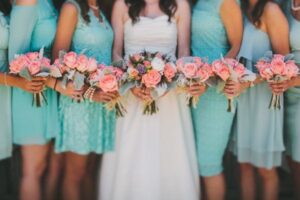 teal bridesmaid dresses coral bouquet